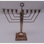 A hallmarked silver Menorah of tapering rectangular form on raised square base with Star of David