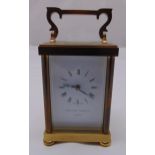 Matthew Norman brass carriage clock of customary form, white enamel dial with Roman numerals all