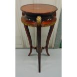 A continental mahogany circular plant stand with brass mounts on three outswept legs, 67 x 31cm
