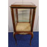 A rectangular mahogany glazed display cabinet with applied brass mounts, the hinged door revealing a