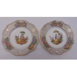 A pair of 19th century Meissen reticulated cabinet plates decorated with Watteauesque images and