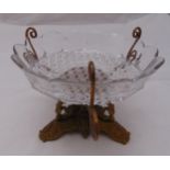 A gilt metal table centre piece supporting a scalloped cut glass bowl, 20 x 26cm