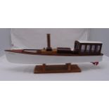 A scale model steam engine sailing boat titled Christina with glazed cabin and copper funnel on