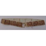 An oriental articulated jade belt, the panels carved with mythical figures, 94.5cm (w)