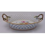 A Meissen oval fruit basket with pierced sides and two naturalistic handles with applied flowers