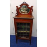 An Edwardian rectangular mahogany display cabinet with mirrored back and hinged glazed door on