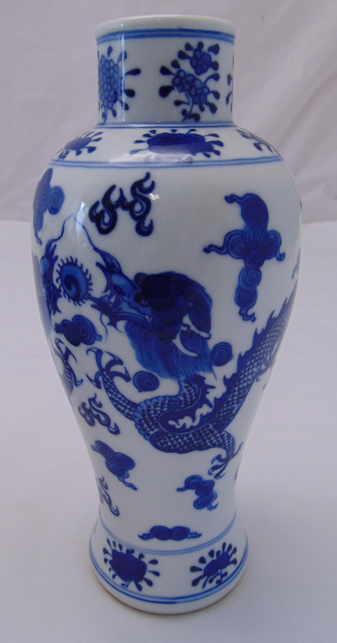 A Chinese blue and white baluster vase decorated with dragons and clouds circa 1900, 26.5cm (h)