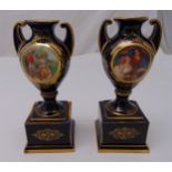 A pair of Vienna baluster vases blue ground with scenes of courting couples and gilded decoration on