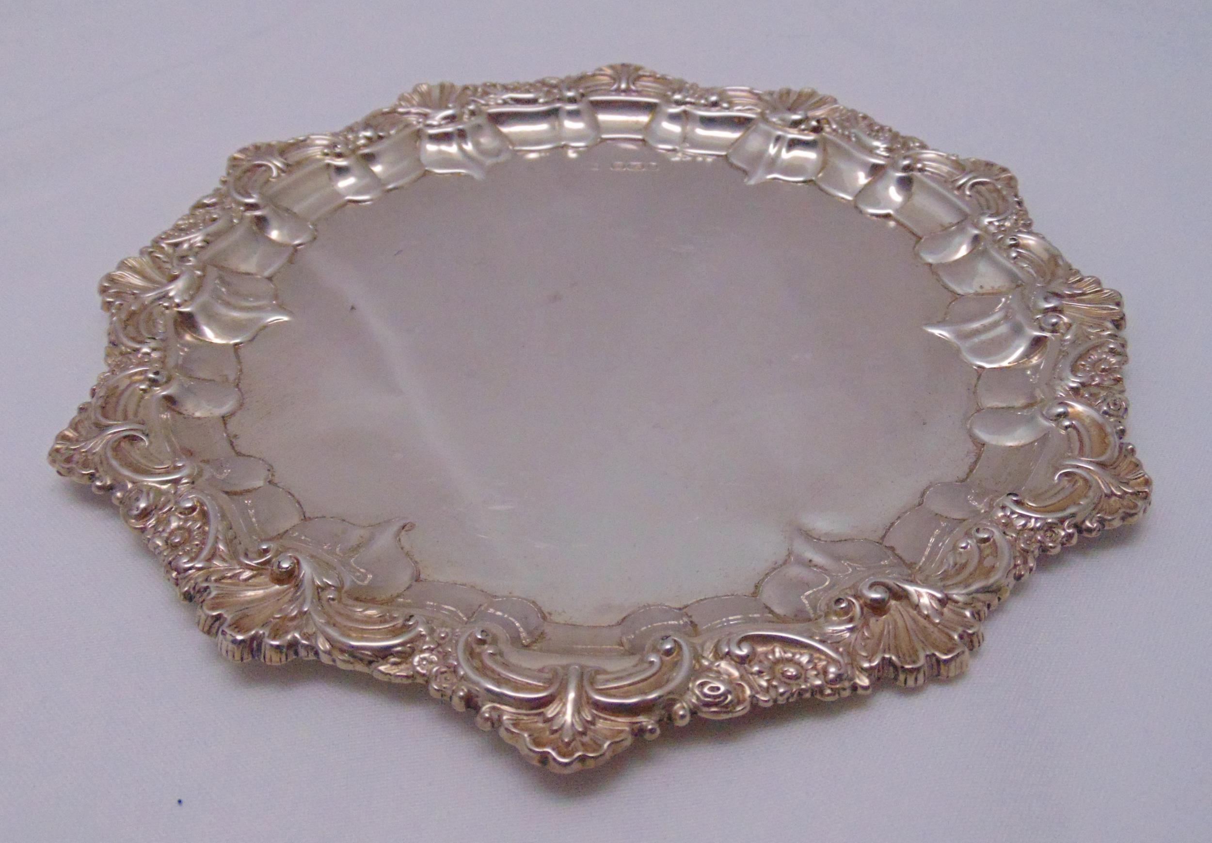 A Victorian hallmarked silver card tray, circular with shell and floral border, Sheffield 1895,