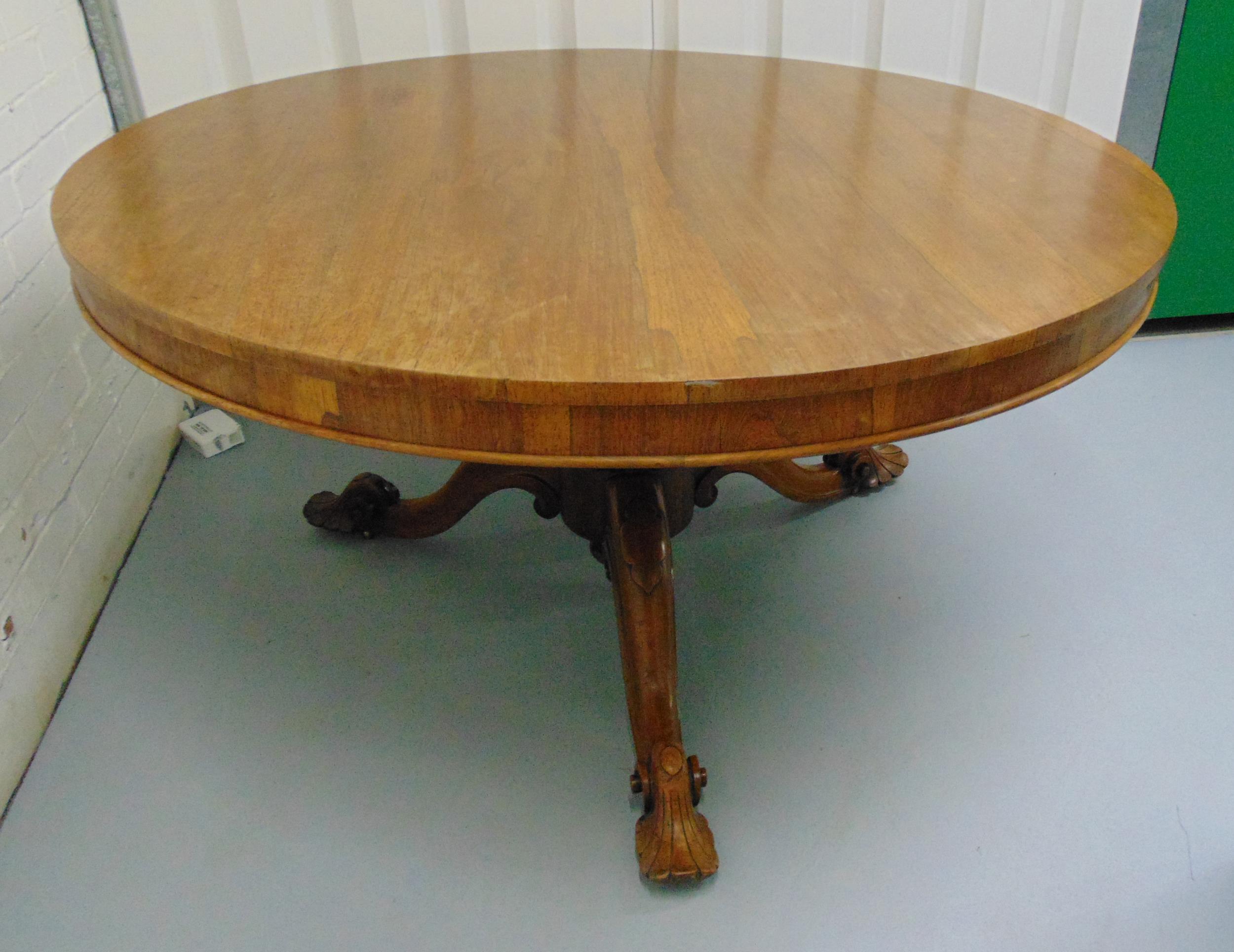 A Victorian mahogany circular tilt top table on three outswept scroll legs, 73 x 137cm