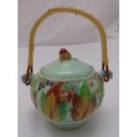 Clarice Cliff biscuit jar and cover decorated to the sides with stylised leaves and berries with