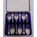 A cased set of hallmarked silver teaspoons with scalloped bowls