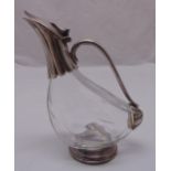A silver plated and glass claret jug of avian form with scroll handle, hinged domed cover on
