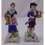 A pair of Chelsea figurines in 18th century attire on gilded square base with scroll feet, with gold
