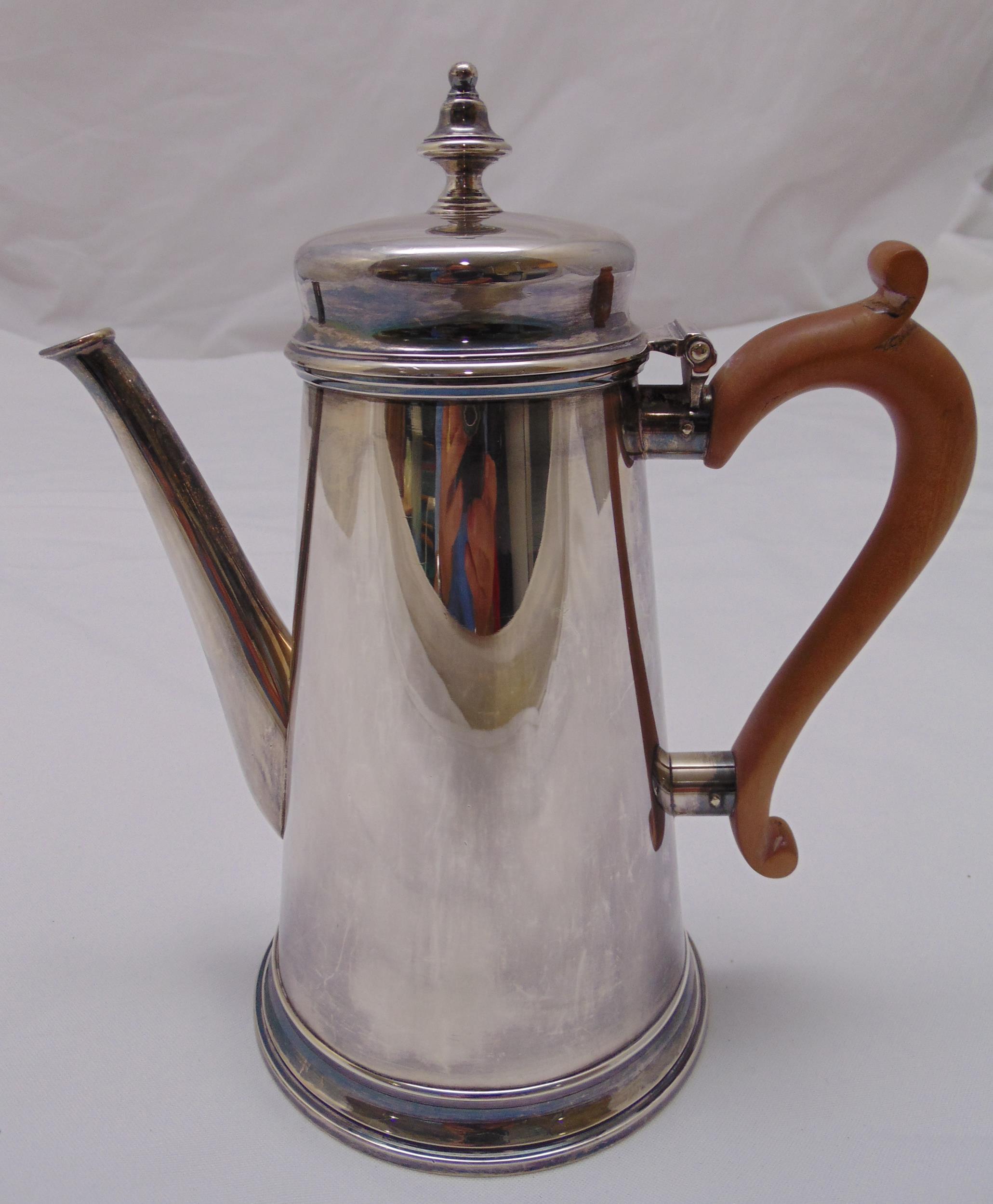 A Georgian style hallmarked silver coffee pot, tapering cylindrical with angled spout and