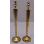A pair of white metal table candlesticks of tapering rectangular form on raised circular bases, 35.