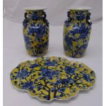 A pair of early 20th century Chinese baluster vases yellow ground decorated with blue flowers and