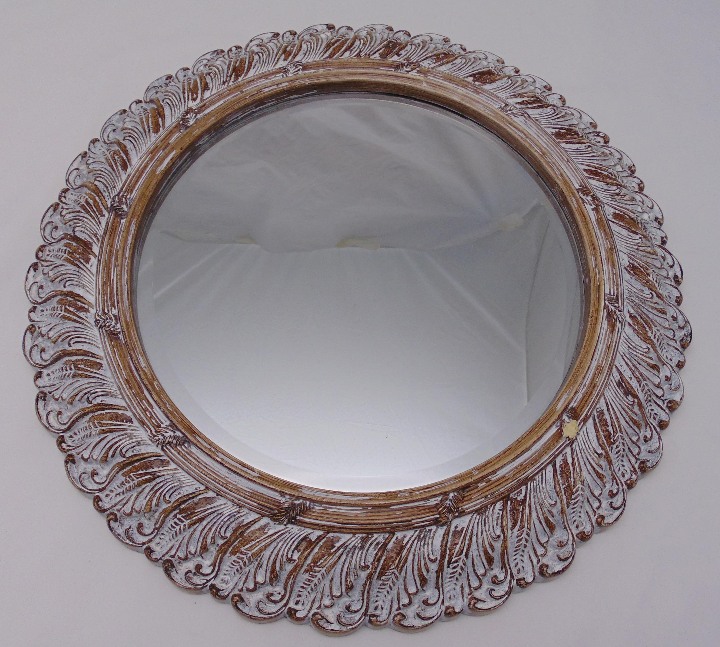 A moulded circular wall mirror with distressed stylised leaf frame, 61cm dia