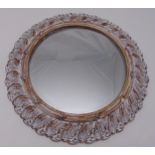 A moulded circular wall mirror with distressed stylised leaf frame, 61cm dia