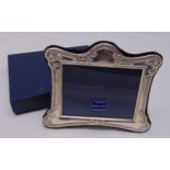 A hallmarked silver mounted photograph frame in original packaging