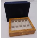 A rectangular walnut watch display case with hinged glazed cover, 28 x 22cm