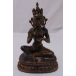 A Chinese bronze seated Buddha on raised lobed oval base, 38.5cm (h)