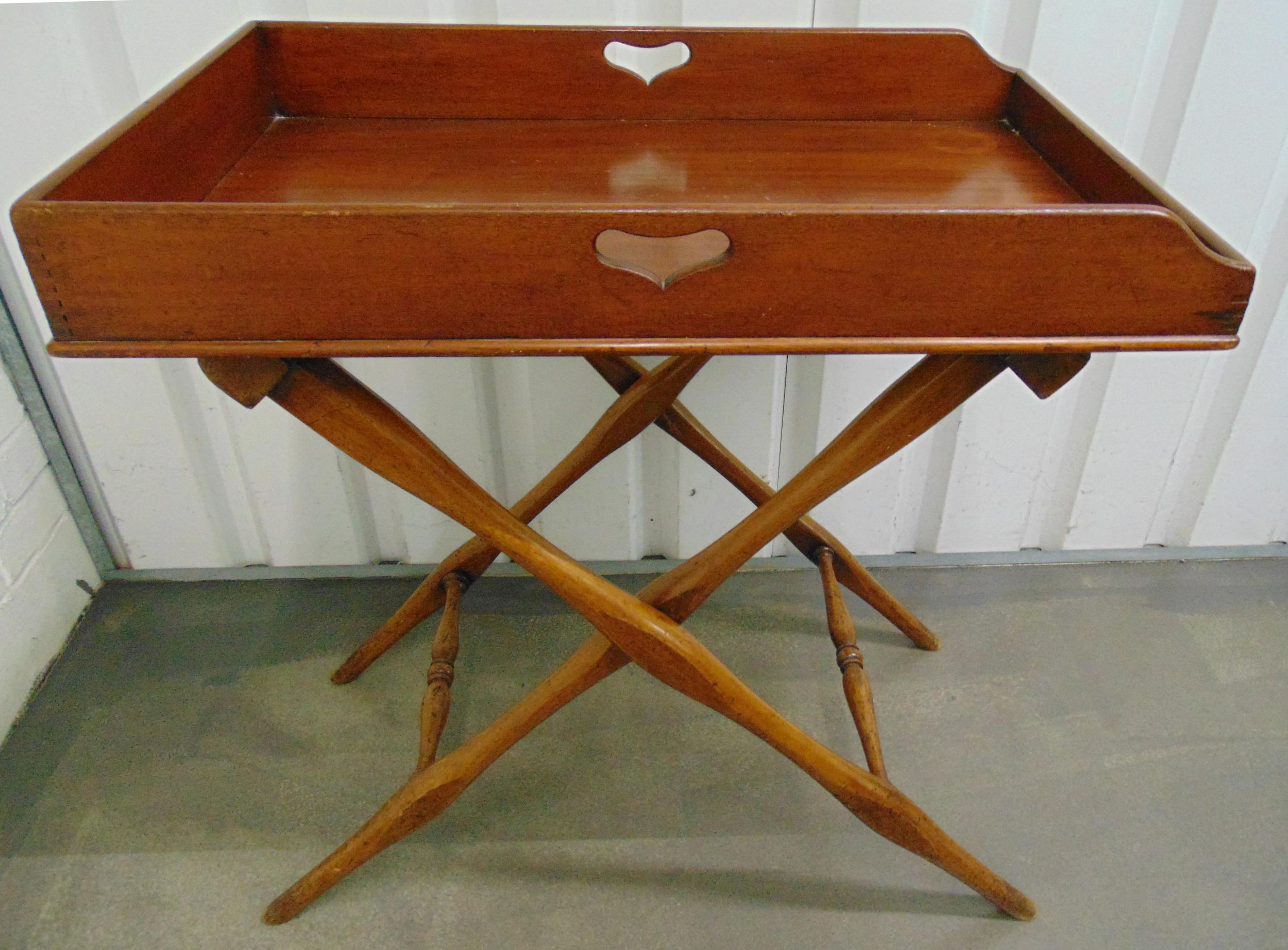 A rectangular mahogany butlers tray on scissor action stand, 81 x 76 x 49.5cm, A/F