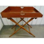 A rectangular mahogany butlers tray on scissor action stand, 81 x 76 x 49.5cm, A/F