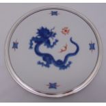 A Meissen charger decorated with a Blue Ming Dragon and silvered border, marks to the base, 33cm