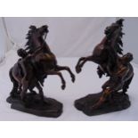 A pair of antique bronze Marley horses and trainers on naturalistic bases after Guillaume Coustou,