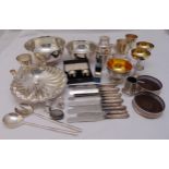 A quantity of silver plate to include a cocktail shaker, coaster, bowls, cups, napkin rings and