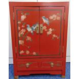 An oriental rectangular red lacquered cabinet, the hinged doors with birds and prunus blossom