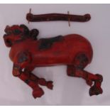 A Chinese red lacquered hardwood dog puppet with articulated legs, approx 48cm (l)