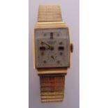 A 14ct gold ladies wristwatch on a gold plated expanding bracelet