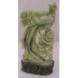 A carved Jadeite figurine of a bird and flowers on raised hardstone stand, 47.5cm (h)