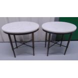 A pair of oval marble top side tables on tapering cylindrical metal supports, 50.5 x 51.5 x 36.5cm