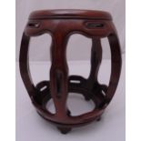 An oriental wooden garden seat of pierced barrel form on bracket feet, 45cm (h)