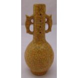 A Chinese yellow ground crackle glazed vase with side handles, character marks to the base, 22.