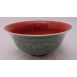 Chinese celadon rice bowl decorated with scrolls, leaves and iron red interior wash, character marks