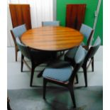 A Rosewood circular dining table and six matching chairs with upholstered seats and backs, to