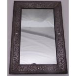 A rectangular silver plated wall mirror with scroll chased beaded border, 53 x 36cm