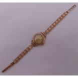 J W Benson 9ct gold ladies wristwatch on a 9ct gold articulated bracelet with two spare links
