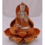 A Chinese porcelain Guanyin Buddha seated in a lotus leaf on raised naturalistic base, 31.5cm (h)