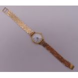 Rotary ladies gold plated wristwatch on a 9ct gold articulated bracelet