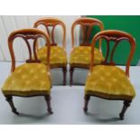 A set of four mahogany upholstered dining chairs with original castors