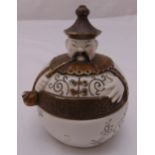 A novelty oriental style dish and cover of globular form of a rotund gentleman smoking an opium