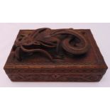 An oriental carved wooden jewellery box with high relief carved dragon to the hinged cover, 13 x