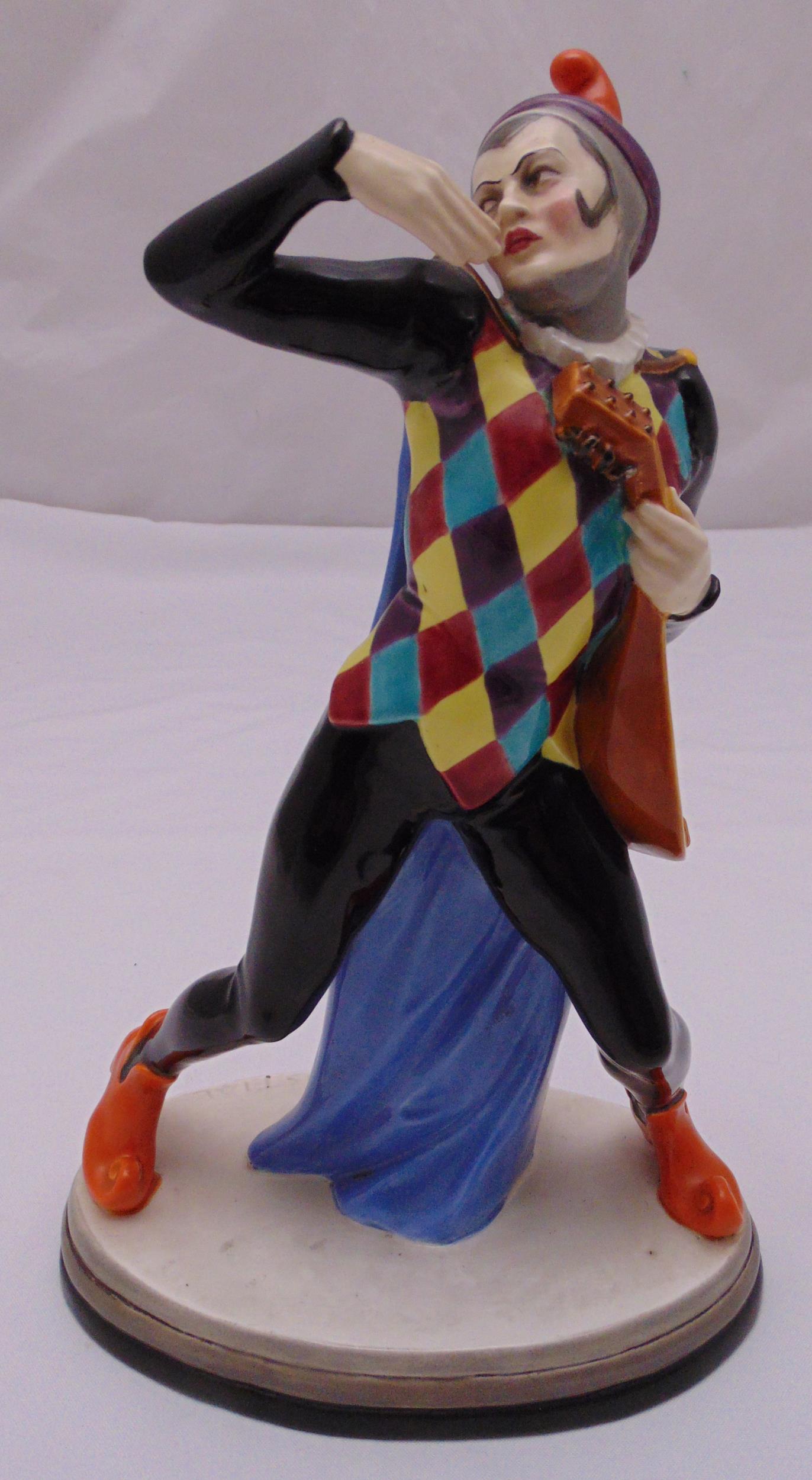 A Keranos mid 20th century porcelain figurine of a jester, marks to the base, signed J Kostval, 32.