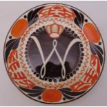 A late 19th century Dutch Coronation plate, hand painted with red and black geometric patterns