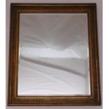 A rectangular gilded frame bevelled edge wall mirror, 75.5 x 64cm